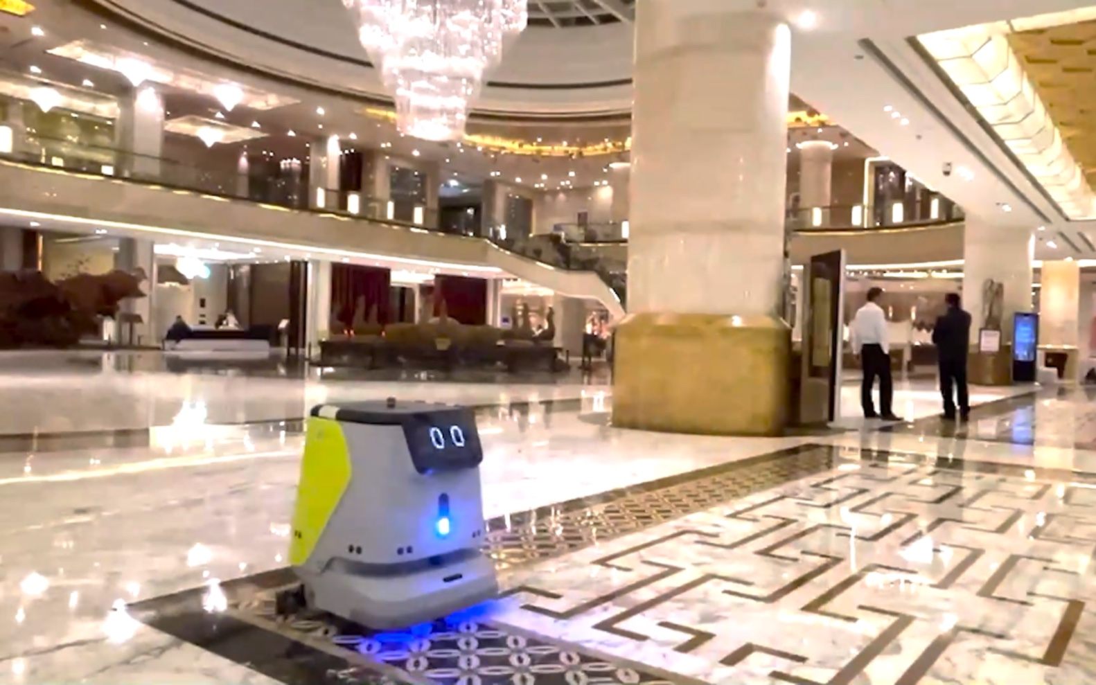 Autonomous floor-scrubbing robot working a hotel corridor