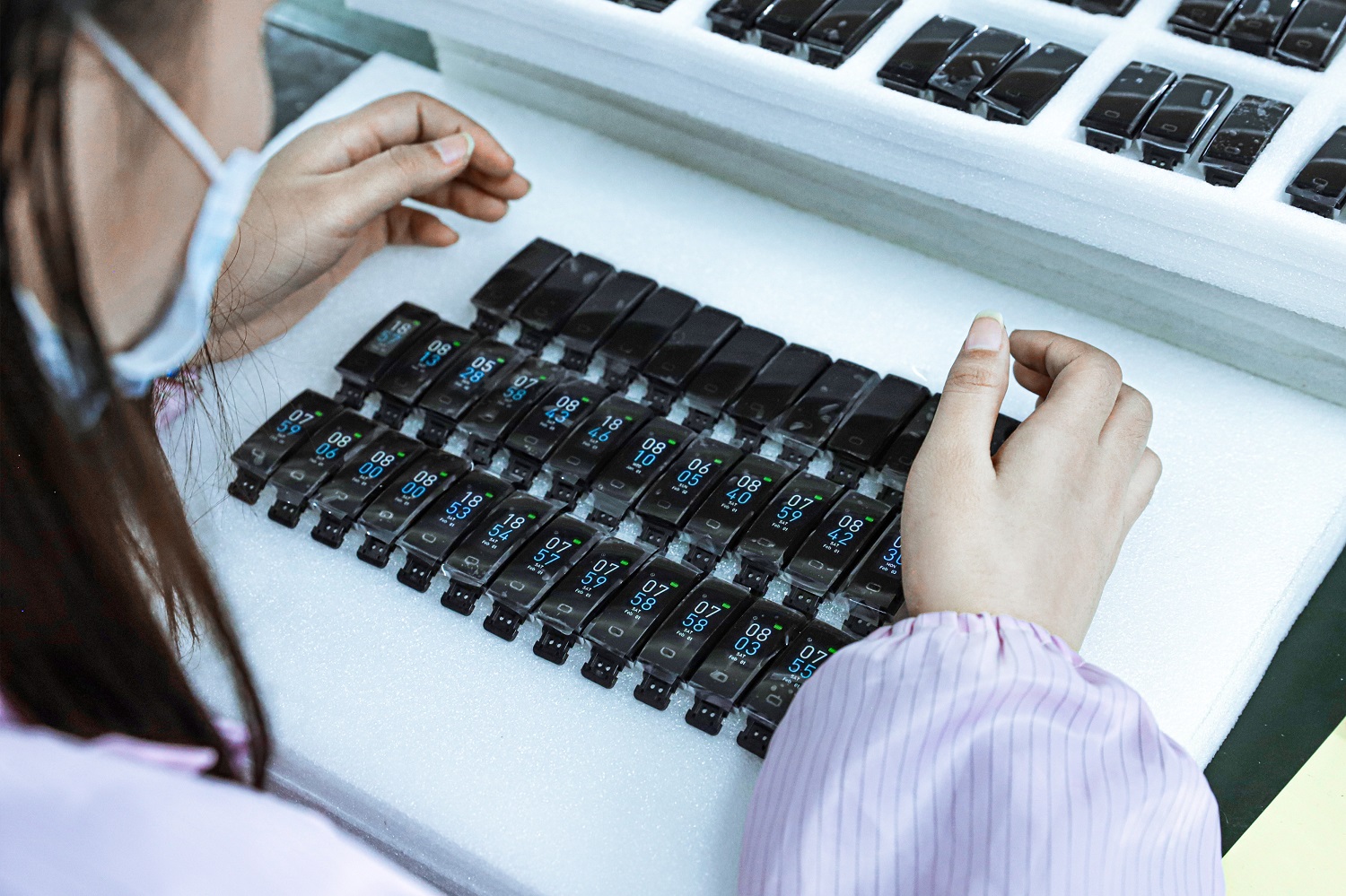 AI glasses assembled on a production bench with functional testers