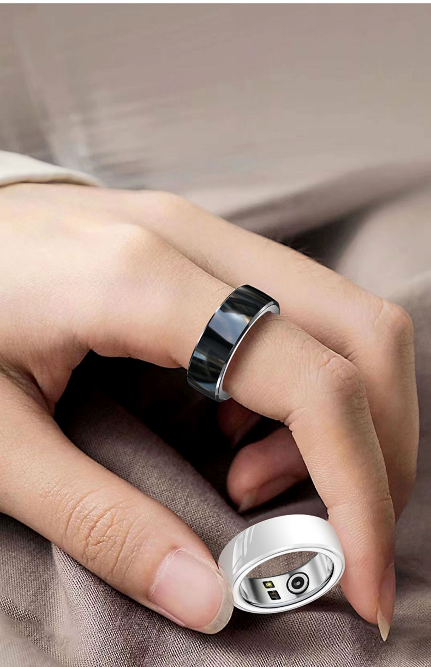 Slim aluminium-titanium smart health ring with a ceramic inner surface on a studio backdrop